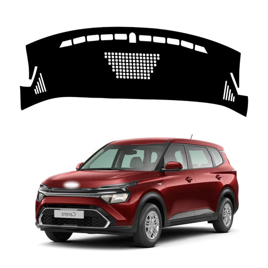A black dashboard cover designed for a Kia Carens vehicle, depicted in isolation above the vehicle's dashboard.
